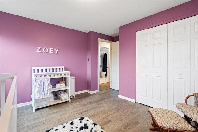 bedroom featuring wood-type flooring and a closet