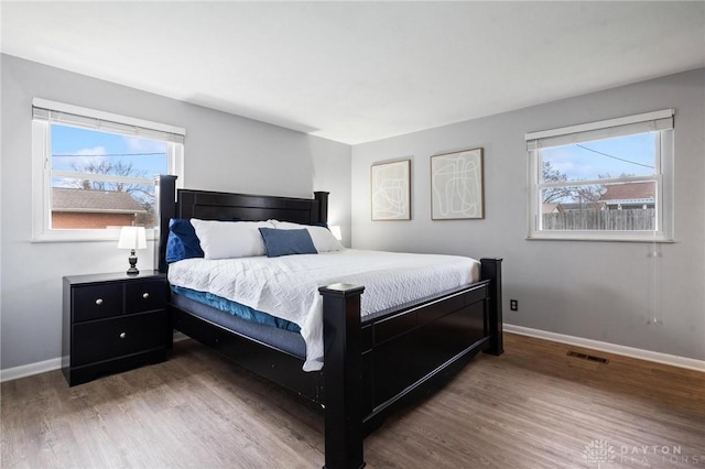 bedroom with dark hardwood / wood-style floors