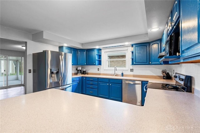 kitchen with blue cabinetry, sink, and appliances with stainless steel finishes