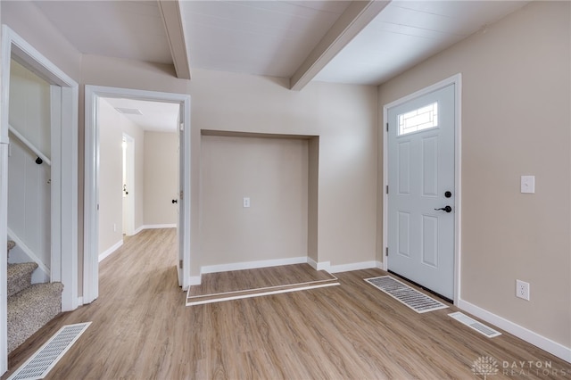 entryway with beam ceiling and light hardwood / wood-style flooring