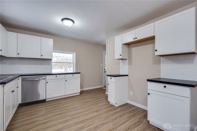 kitchen featuring tasteful backsplash, dishwasher, and white cabinets