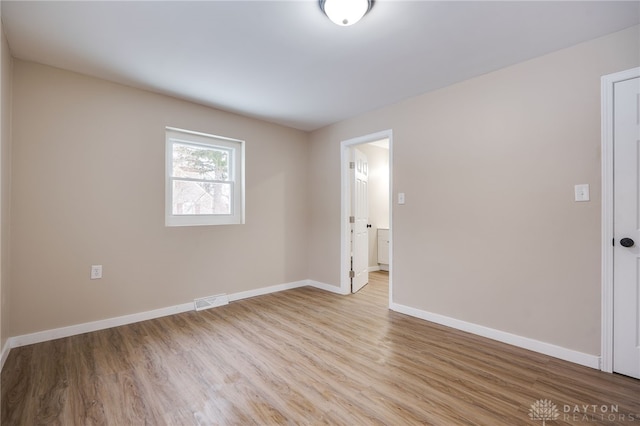 empty room with light hardwood / wood-style floors