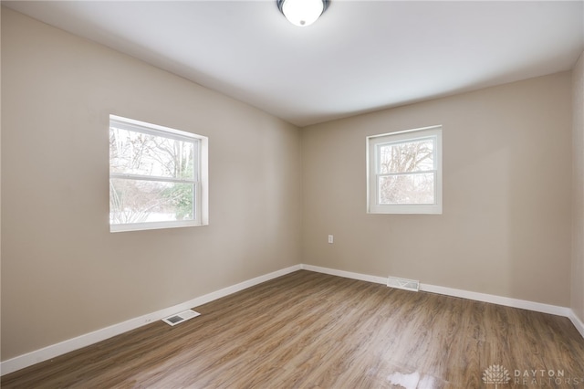 unfurnished room featuring hardwood / wood-style floors