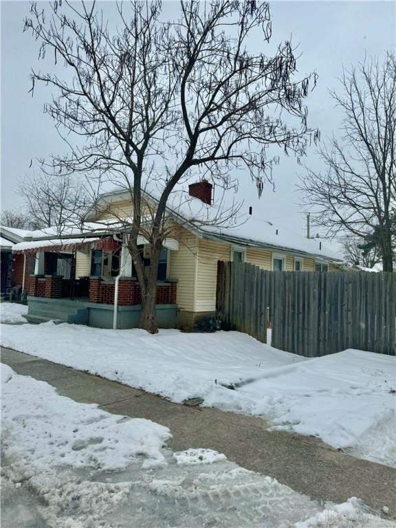 view of snow covered exterior with covered porch