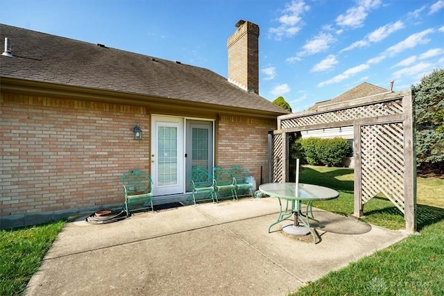 back of property featuring a patio area and a yard