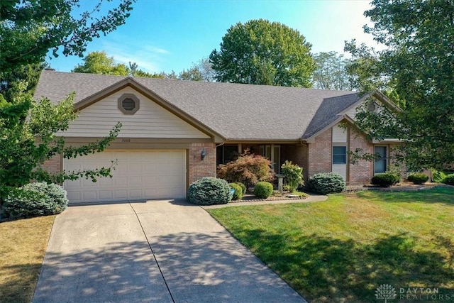 ranch-style home featuring a front lawn and a garage