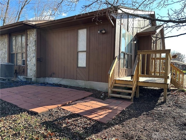 view of side of home featuring central AC unit and a patio area