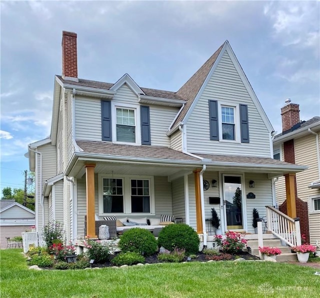 view of front of property with a porch and a front lawn