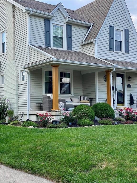 view of front of home featuring a porch and a front yard