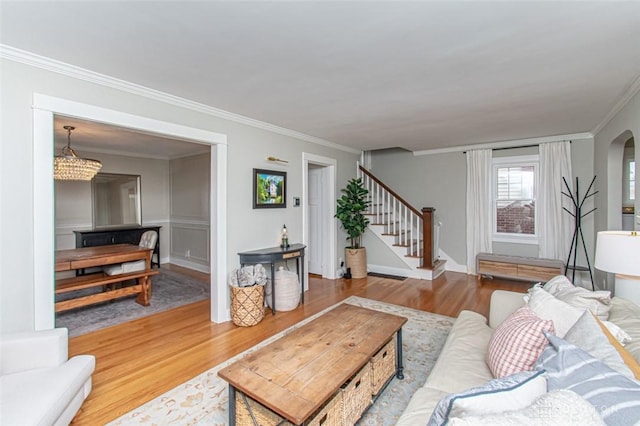 living room with ornamental molding and wood-type flooring