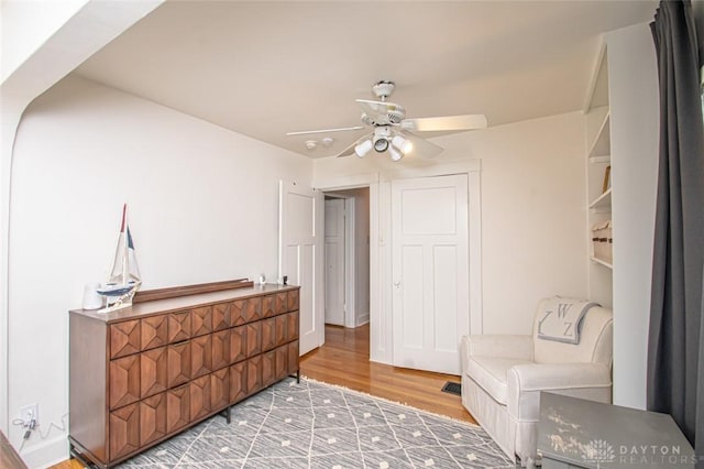 sitting room with hardwood / wood-style flooring and ceiling fan