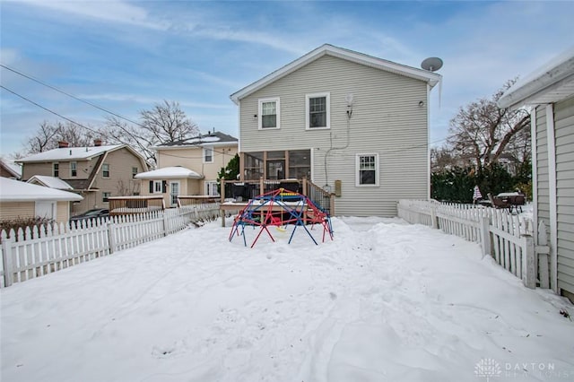 view of snow covered rear of property