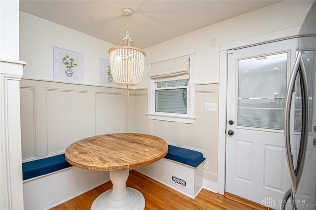 dining area featuring hardwood / wood-style floors and a notable chandelier