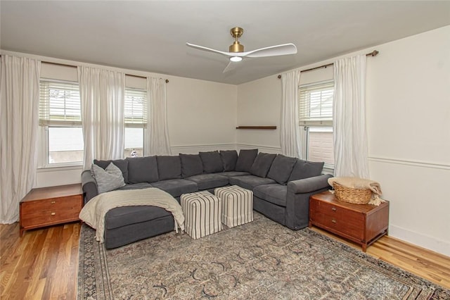 living room featuring hardwood / wood-style flooring, ceiling fan, and a healthy amount of sunlight