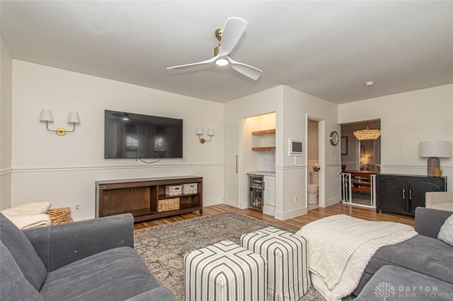 living room with wine cooler, wood-type flooring, and ceiling fan