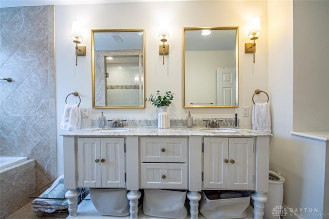 bathroom with vanity and a tub to relax in