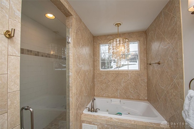 bathroom featuring separate shower and tub and tile walls