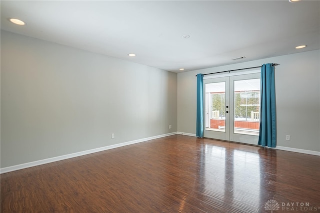 unfurnished room with dark hardwood / wood-style flooring and french doors