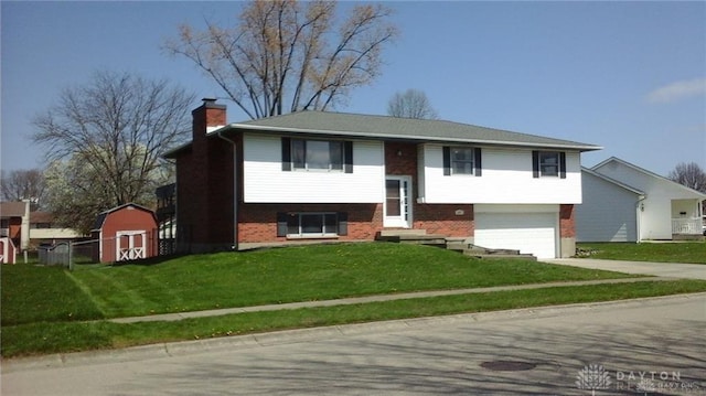 raised ranch with a front yard, a garage, and a shed