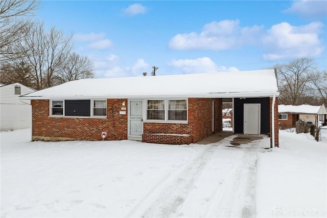 single story home with a carport and brick siding