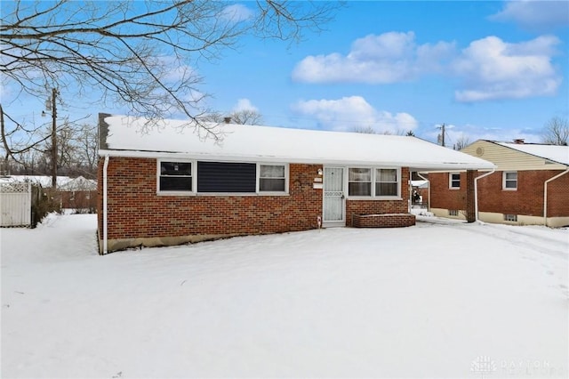 ranch-style house featuring brick siding