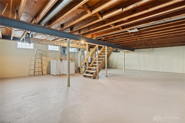 basement with washing machine and dryer, electric panel, and stairs