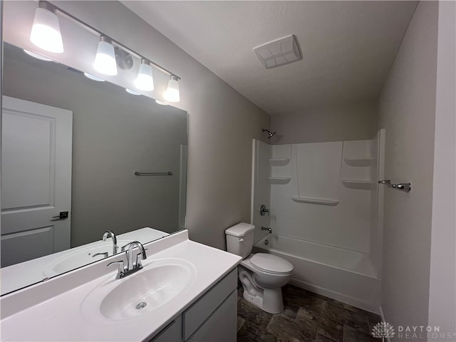 full bathroom featuring vanity, toilet, bathtub / shower combination, and a textured ceiling