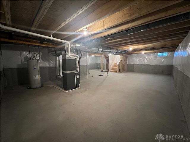 basement featuring heating unit and water heater