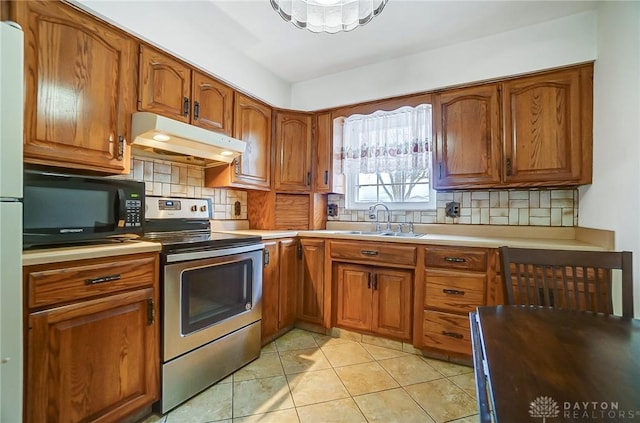 kitchen with backsplash, electric range, light tile patterned floors, and sink