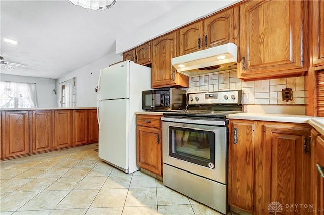 kitchen featuring electric stove, ceiling fan, backsplash, white refrigerator, and light tile patterned flooring