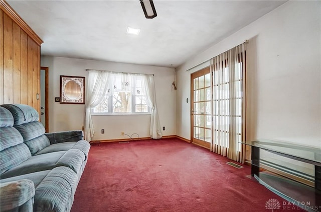 sitting room with dark colored carpet