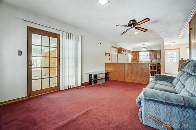 living room with ceiling fan and carpet flooring