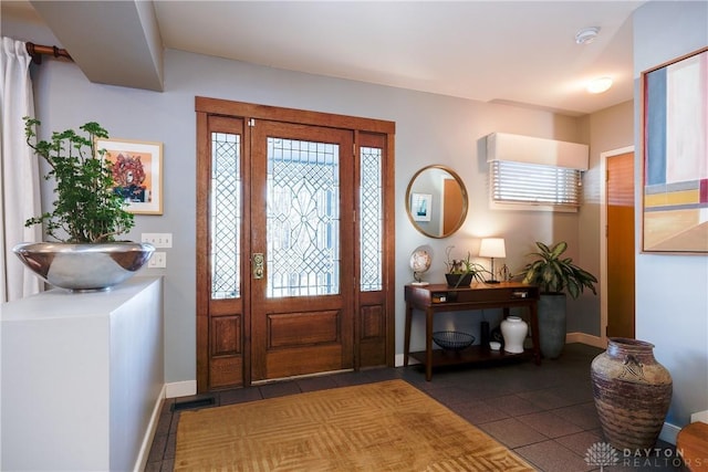 entryway featuring dark tile patterned floors