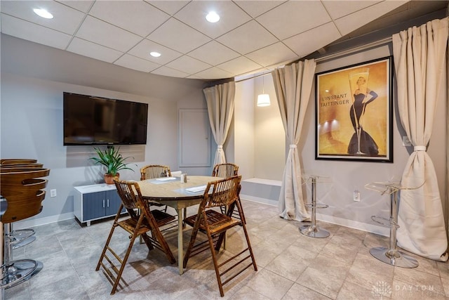 dining area with a paneled ceiling