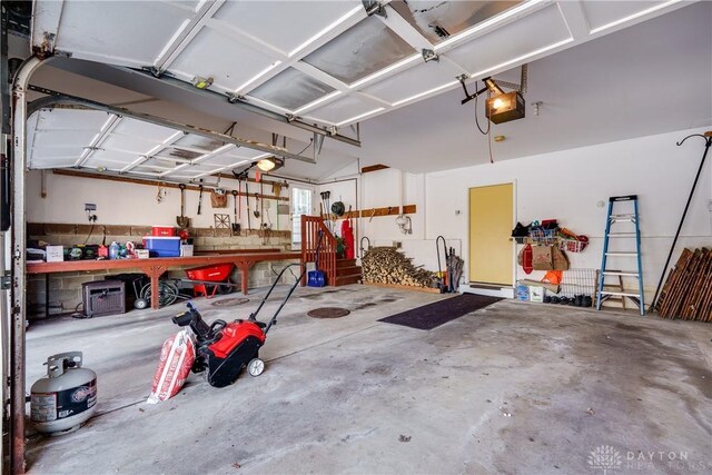 garage with a workshop area and a garage door opener