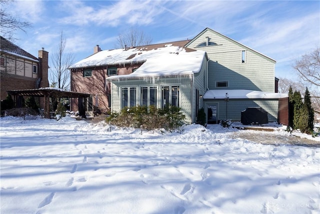 view of snow covered rear of property