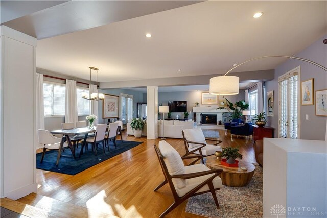 dining room with light hardwood / wood-style floors and a notable chandelier