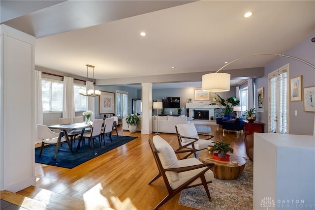 dining area with an inviting chandelier and light hardwood / wood-style flooring