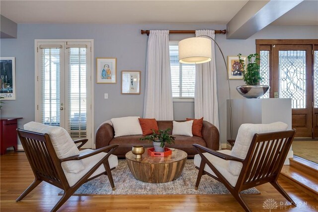 sitting room featuring light wood-type flooring and french doors