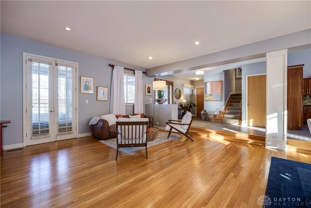 living room featuring french doors and light wood-type flooring