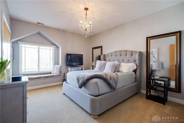 bedroom featuring light colored carpet and a notable chandelier