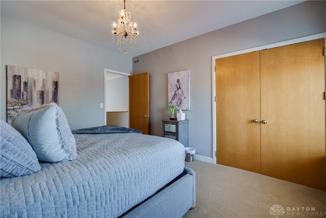 carpeted bedroom with an inviting chandelier