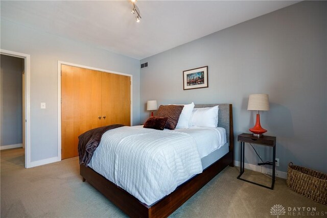 carpeted bedroom featuring a closet