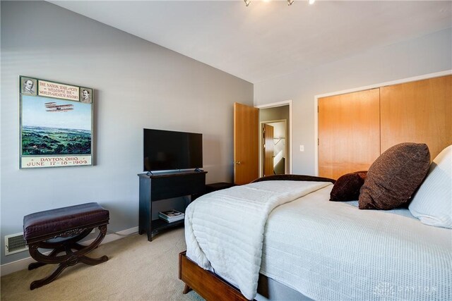 bedroom featuring a closet and light carpet