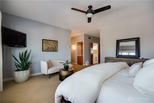 carpeted bedroom with ceiling fan and ensuite bath