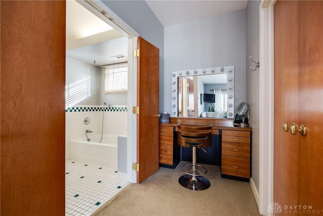 bathroom featuring a tub to relax in and tile patterned flooring