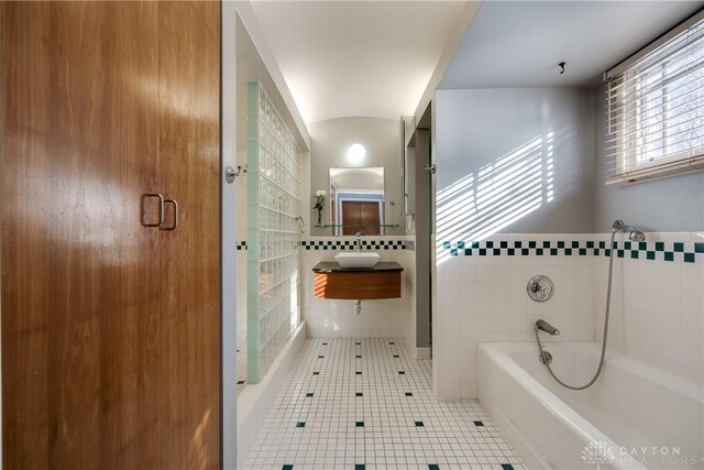 bathroom featuring sink, a bathtub, and tile patterned flooring