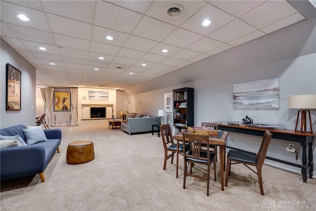 dining space featuring light carpet