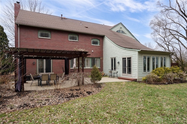 rear view of property with a pergola, a yard, and a patio