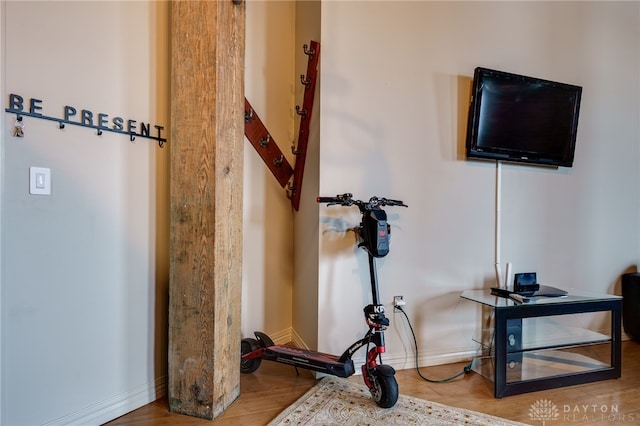 exercise room with hardwood / wood-style flooring